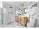 Elegant bathroom featuring marble accents, double vanity, gold hardware, and glass walk-in shower at 1124 Upchurch St, Raleigh, NC 27610