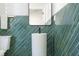 Bathroom with stylish, emerald tile, pedestal sink, and toilet at 1124 Upchurch St, Raleigh, NC 27610