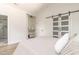 Bedroom featuring a barn door closet, shelving unit, and an ensuite bathroom with glass shower at 1124 Upchurch St, Raleigh, NC 27610
