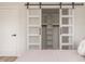 Bedroom with large sliding closet doors featuring frosted glass and a built-in shelving unit at 1124 Upchurch St, Raleigh, NC 27610