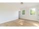 Bright bedroom boasts two large windows and light-colored wood flooring at 1124 Upchurch St, Raleigh, NC 27610