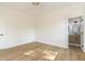 Bright room with wood-look flooring, white walls and trim, and an attached bathroom at 1124 Upchurch St, Raleigh, NC 27610