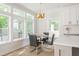 Charming dining nook with an elegant light fixture and large windows bringing in natural light at 1124 Upchurch St, Raleigh, NC 27610