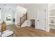 Open-concept entryway featuring wood floors, a staircase, and a built-in pet nook at 1124 Upchurch St, Raleigh, NC 27610