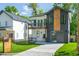 An eye-catching two-story home with unique siding, a two-car garage, and manicured landscaping at 1124 Upchurch St, Raleigh, NC 27610