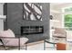 Stylish fireplace featuring black herringbone tile, modern art, and built-in shelving at 1124 Upchurch St, Raleigh, NC 27610