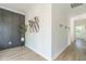 Hallway with decorative gray wall treatment, hardwood floors, and artwork at 1124 Upchurch St, Raleigh, NC 27610