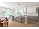 Beautiful kitchen with an island with bar seating, shaker style cabinets, and modern lighting at 1124 Upchurch St, Raleigh, NC 27610