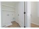 Clean laundry room featuring open shelving and a utility sink hookup at 1124 Upchurch St, Raleigh, NC 27610