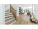 Open concept living room with hardwood floors, staircase, and view of outdoor patio at 1124 Upchurch St, Raleigh, NC 27610