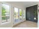 Bright living room with a decorative wall, hardwood floors, and glass doors to the outside deck at 1124 Upchurch St, Raleigh, NC 27610