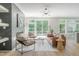 Bright living room featuring a modern fireplace, stylish seating, and sliding doors to outdoor space at 1124 Upchurch St, Raleigh, NC 27610