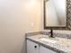 Bathroom vanity featuring granite countertop, framed mirror, and modern faucet at 113 Weatherstone Dr # B, Chapel Hill, NC 27514