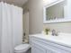 This bathroom features a shower-tub combo, white vanity, a mirror and decorative floral accents at 113 Weatherstone Dr # B, Chapel Hill, NC 27514