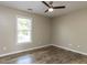 This bedroom offers wood-look floors and a ceiling fan at 113 Weatherstone Dr # B, Chapel Hill, NC 27514