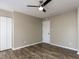This bedroom features wood-look floors, closet, and a ceiling fan at 113 Weatherstone Dr # B, Chapel Hill, NC 27514