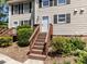 Inviting entrance stairs leading to a townhome with neutral siding and black shutters at 113 Weatherstone Dr # B, Chapel Hill, NC 27514