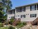 Charming townhome featuring neutral siding, black shutters, and inviting entry stairs at 113 Weatherstone Dr # B, Chapel Hill, NC 27514