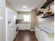 Eat-in kitchen featuring white appliances and cabinets, granite countertops, and wood flooring at 113 Weatherstone Dr # B, Chapel Hill, NC 27514