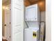 Convenient laundry area with stacked washer and dryer, adjacent to a storage closet at 113 Weatherstone Dr # B, Chapel Hill, NC 27514