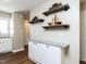 Open living space with wood floors, granite countertop, and decorative floating shelves at 113 Weatherstone Dr # B, Chapel Hill, NC 27514
