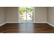 Living area with wood floors and sliding glass doors leading to the outdoor patio at 113 Weatherstone Dr # B, Chapel Hill, NC 27514