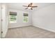 Bedroom with a ceiling fan and two large windows offering plenty of natural light at `120 Red Hawk Pl, Smithfield, NC 27577