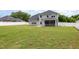 Back exterior of home showcasing the large lawn, screened in porch at `120 Red Hawk Pl, Smithfield, NC 27577