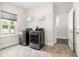 Bright laundry room features modern appliances, window and practical storage at `120 Red Hawk Pl, Smithfield, NC 27577
