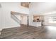 Open-concept living area with hardwood floors, a staircase, and a view of the modern kitchen at `120 Red Hawk Pl, Smithfield, NC 27577