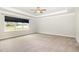 Spacious main bedroom with a tray ceiling, plush carpeting, and a large window at `120 Red Hawk Pl, Smithfield, NC 27577