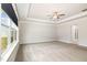 Spacious main bedroom features a tray ceiling, ceiling fan and large windows offering plenty of natural light at `120 Red Hawk Pl, Smithfield, NC 27577