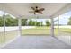 Relaxing screened porch with fan, offering views of the backyard at `120 Red Hawk Pl, Smithfield, NC 27577