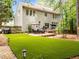 Expansive backyard featuring lush artificial turf, a spacious deck, and patio seating for outdoor enjoyment at 1204 Benoit Pl, Apex, NC 27502