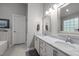 Bathroom featuring a double sink vanity with white cabinets, marble countertops, and tiled floors at 1204 Benoit Pl, Apex, NC 27502