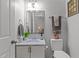 Cozy bathroom featuring a vanity with marble countertop, modern fixtures, and neutral decor at 1204 Benoit Pl, Apex, NC 27502
