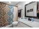 Bathroom featuring a marble countertop, framed mirror, and a shower/tub combination with patterned curtain at 1204 Benoit Pl, Apex, NC 27502