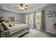 Bedroom featuring a tray ceiling, ceiling fan, multiple windows offering ample natural light and great views at 1204 Benoit Pl, Apex, NC 27502