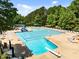 Large community pool with ample seating, a diving board, and a slide, perfect for summer fun and relaxation at 1204 Benoit Pl, Apex, NC 27502