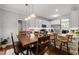 Dining area that flows to the kitchen with stainless steel appliances and granite countertops at 1204 Benoit Pl, Apex, NC 27502