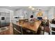 Dining area open to kitchen, living room, and fireplace at 1204 Benoit Pl, Apex, NC 27502