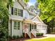 Beautifully designed home with a striking red door, a covered porch, and large windows providing ample natural light at 1204 Benoit Pl, Apex, NC 27502