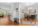 Inviting foyer leading into a dining area and living room with beautiful wood flooring and stylish furnishings at 1204 Benoit Pl, Apex, NC 27502