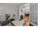 Functional home office with a view of the dining area, a modern desk, and ample natural light at 1204 Benoit Pl, Apex, NC 27502