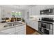 Kitchen area with modern appliances, granite countertops and access to the dining area at 1204 Benoit Pl, Apex, NC 27502