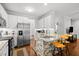 Kitchen featuring granite countertops, stainless steel appliances, and brick accents at 1204 Benoit Pl, Apex, NC 27502