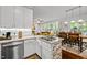 Kitchen area with granite countertops, stainless steel appliances and open to dining area at 1204 Benoit Pl, Apex, NC 27502