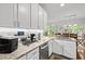 Bright kitchen featuring granite countertops and stainless steel appliances at 1204 Benoit Pl, Apex, NC 27502