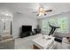 Spacious living room featuring a large TV, comfortable seating, and windows with backyard views at 1204 Benoit Pl, Apex, NC 27502