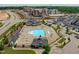 Aerial view of the community, showing a pool, clubhouse, and surrounding homes with lush landscaping at 1223 Brown Velvet Ln, Apex, NC 27523